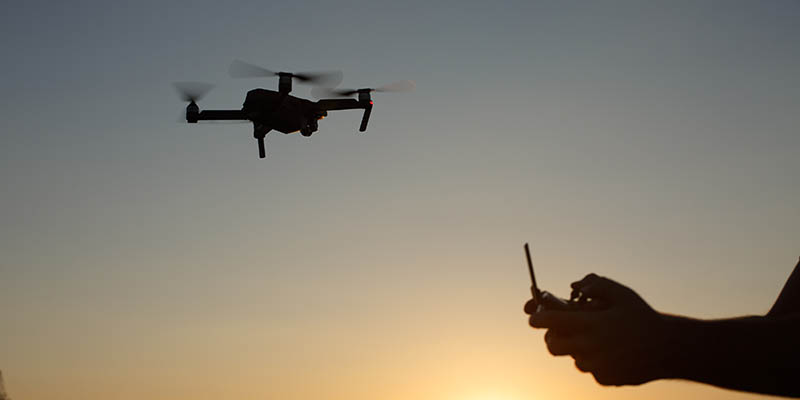 A drone in flight at sunset
