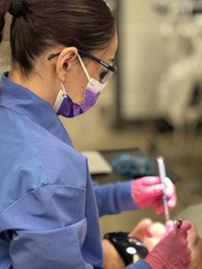 Student performs oral cleaning
