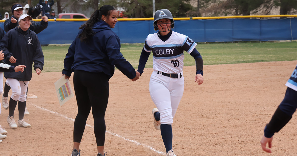 wrestling shoes on a mat with the words 