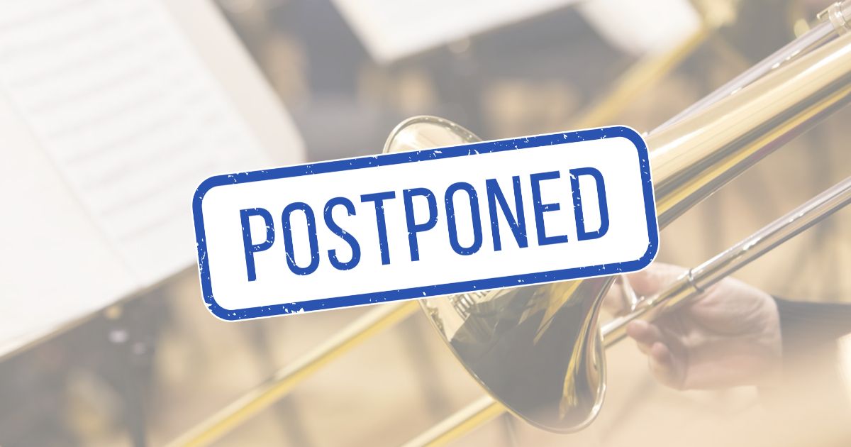 Student playing the trombone with a sign covering the the image that says, 