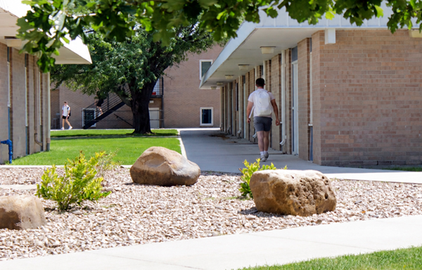 A student walking in the courtyard near Tangeman Hall